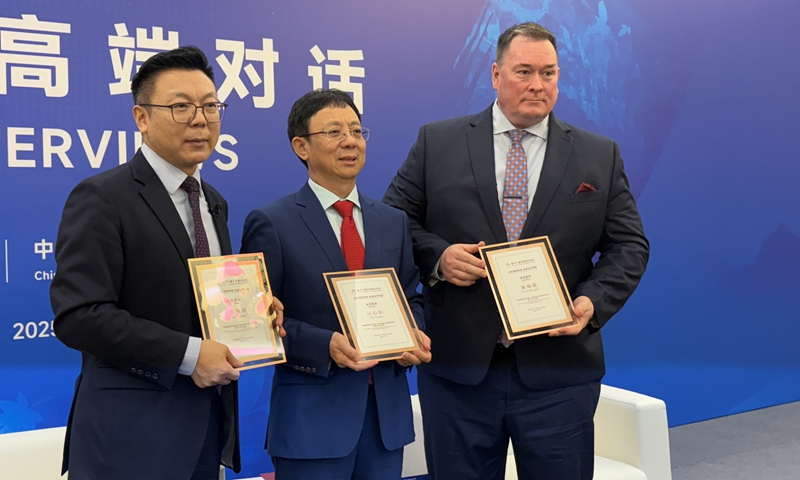 Chad Sbragia, former deputy assistant secretary of defense of US(right),poses for a photo with Wu Xinbo, Dean and professor of the Institute of International Studies of Fudan University (center) during the 12th Beijing Xiangshan Forum on September 17, 2025, in Beijing. Photo: Wang Qi/GT